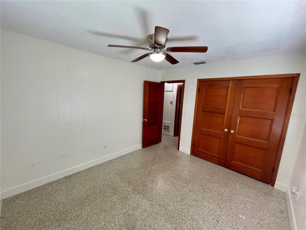 206 Robin Road Altamonte Springs, FL 32701 - Photo 36 of 36 an empty room with closet and a ceiling fan