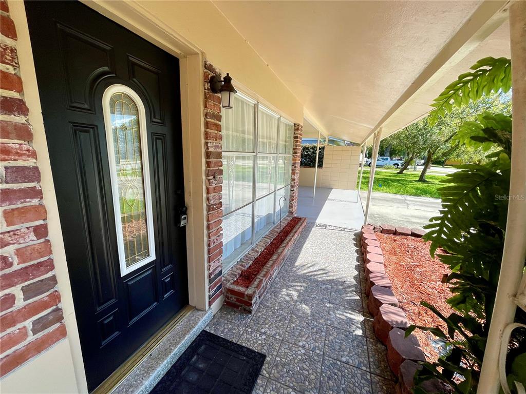 206 Robin Road Altamonte Springs, FL 32701 - Photo 8 of 36 a view of a porch with a floor to ceiling window and a yard