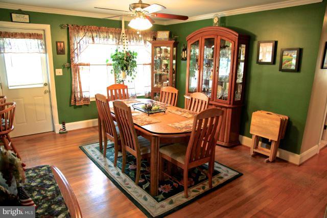 2122 Fallston Road Fallston, MD 21047 - Photo 11 of 30 a dining room with furniture a chandelier and wooden floor