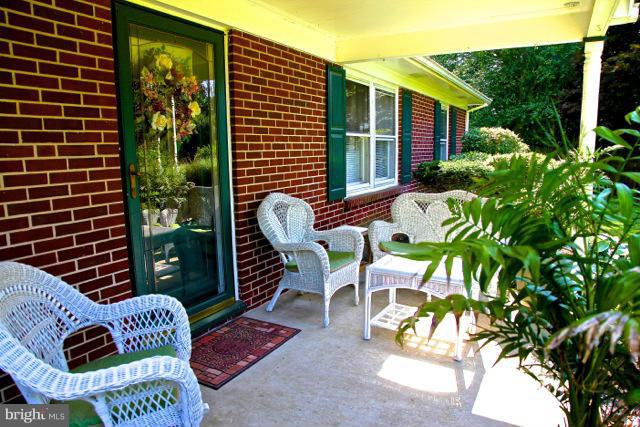 2122 Fallston Road Fallston, MD 21047 - Photo 6 of 30 a balcony with potted plants and a wooden bench