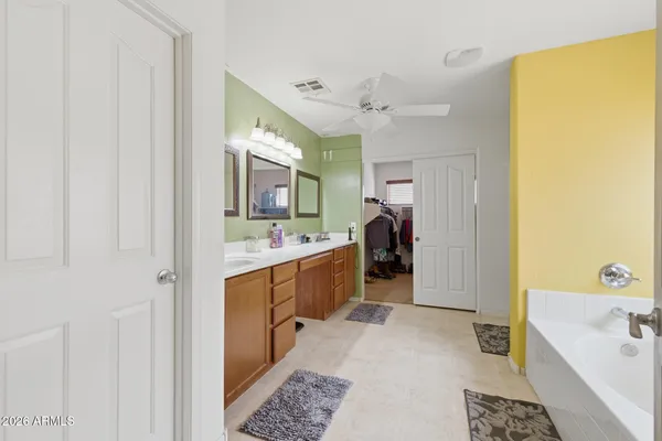 a bathroom with a tub shower and sink