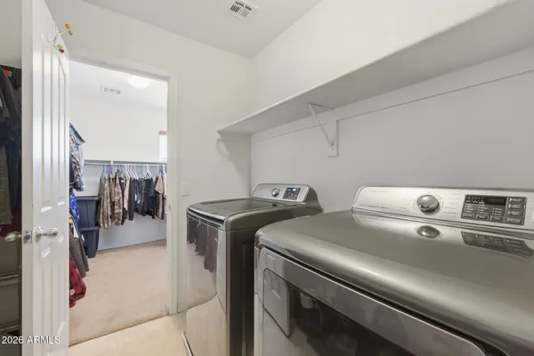 a bedroom with a bed and a ceiling fan