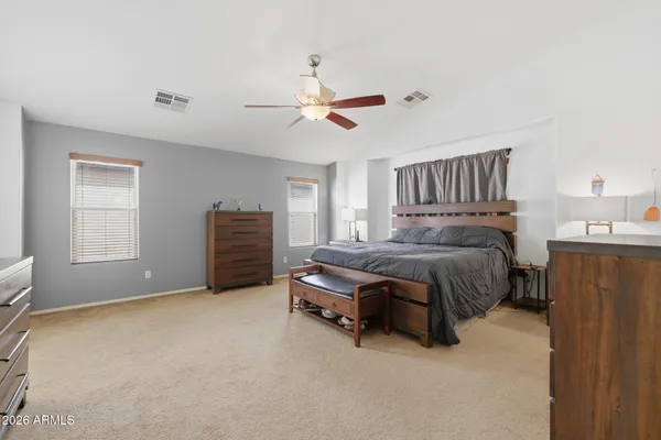 a bedroom with furniture and a ceiling fan