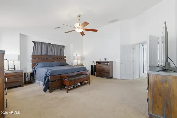 a bedroom with a bed and a flat screen tv