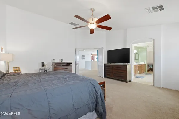 a bedroom with a bed and a flat screen tv