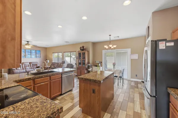 a large kitchen with lots of counter space a sink and stainless steel appliances