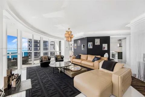 a living room with furniture hard wood floor and a rug