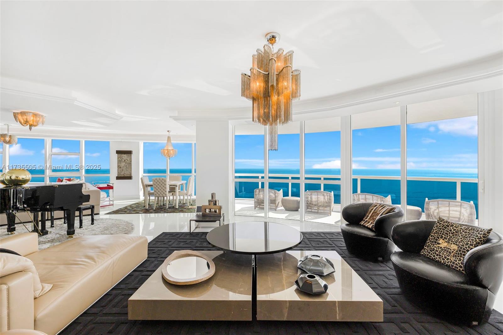 18201 Collins Avenue, Unit PH5109 Sunny Isles Beach, FL 33160 - Photo 15 of 53 a living room with furniture and a large window