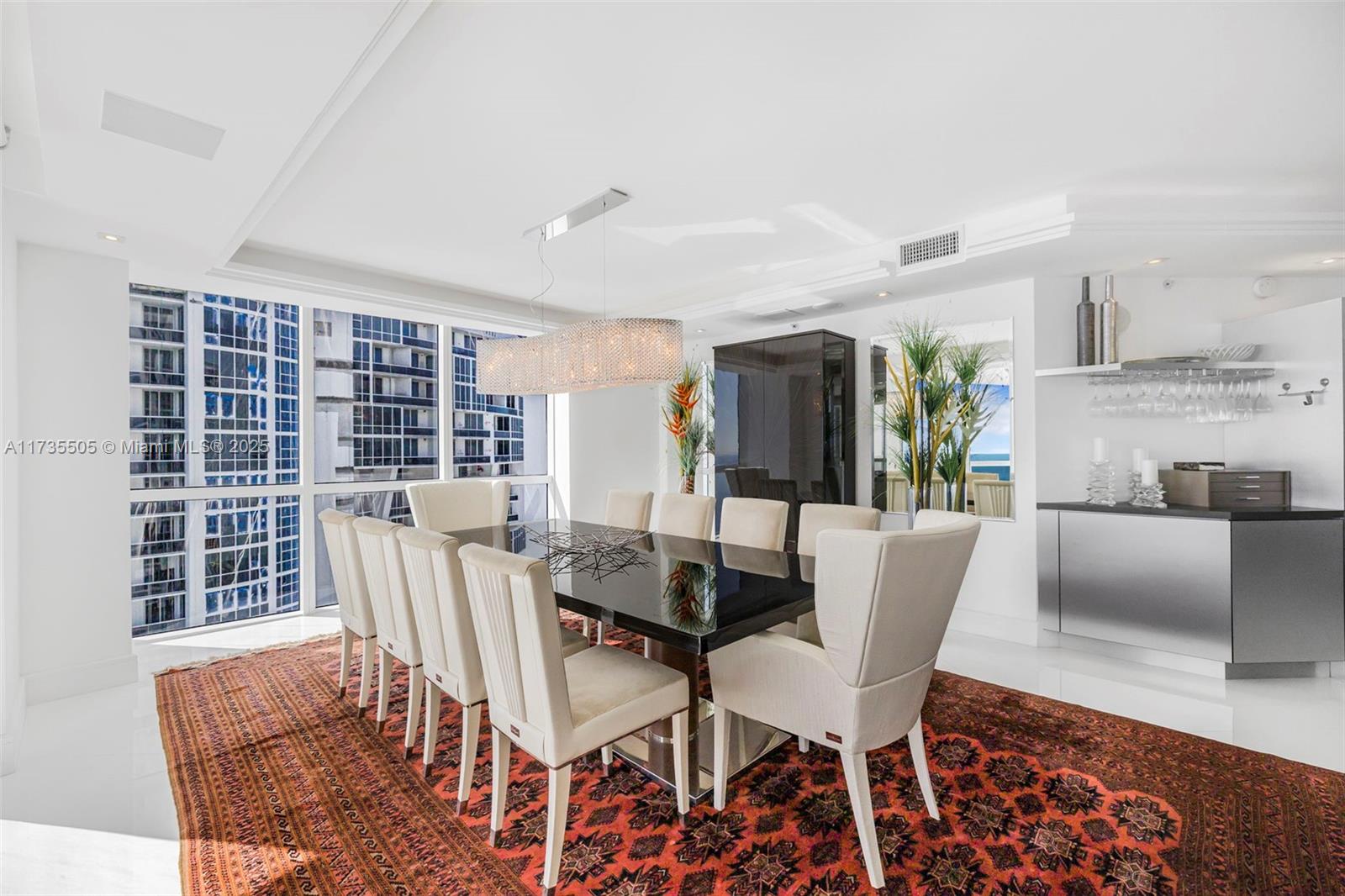 18201 Collins Avenue, Unit PH5109 Sunny Isles Beach, FL 33160 - Photo 22 of 53 a view of a dining room with furniture and wooden floor