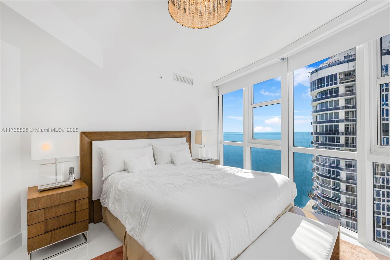 18201 Collins Avenue, Unit PH5109 Sunny Isles Beach, FL 33160 - Photo 23 of 53 a bedroom with a bed and window