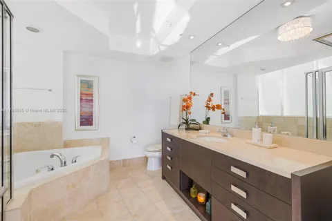 a bathroom with a tub sink and mirror