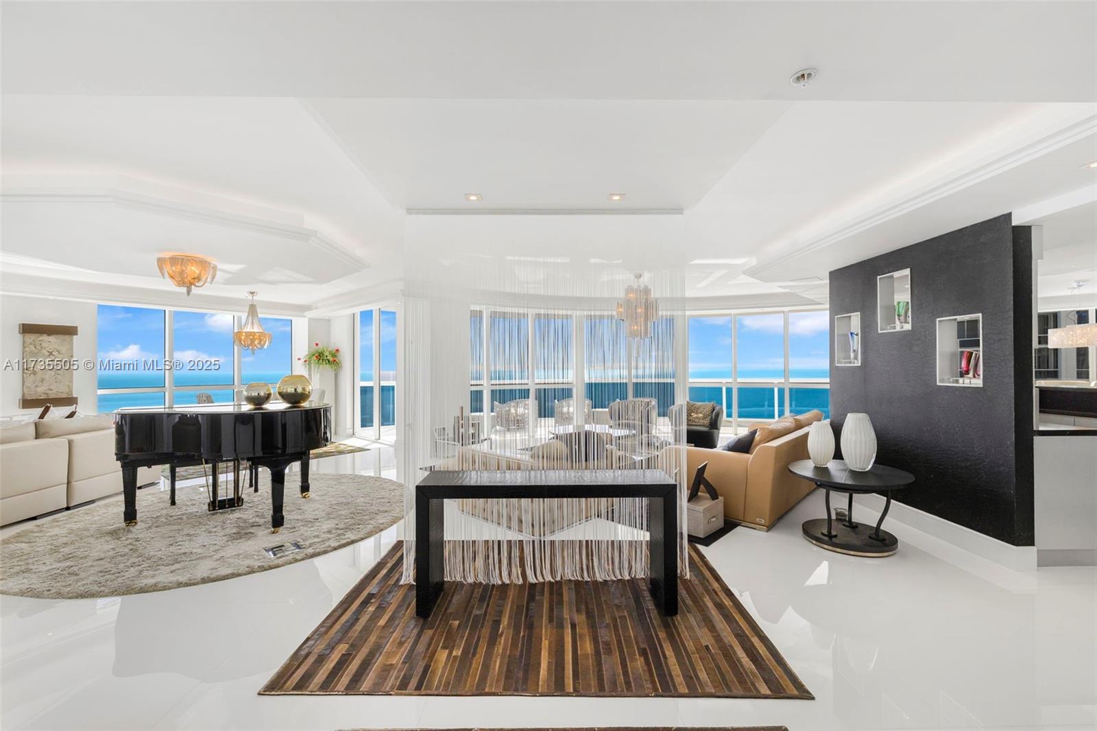 18201 Collins Avenue, Unit PH5109 Sunny Isles Beach, FL 33160 - Photo 3 of 53 a living room with furniture and a table