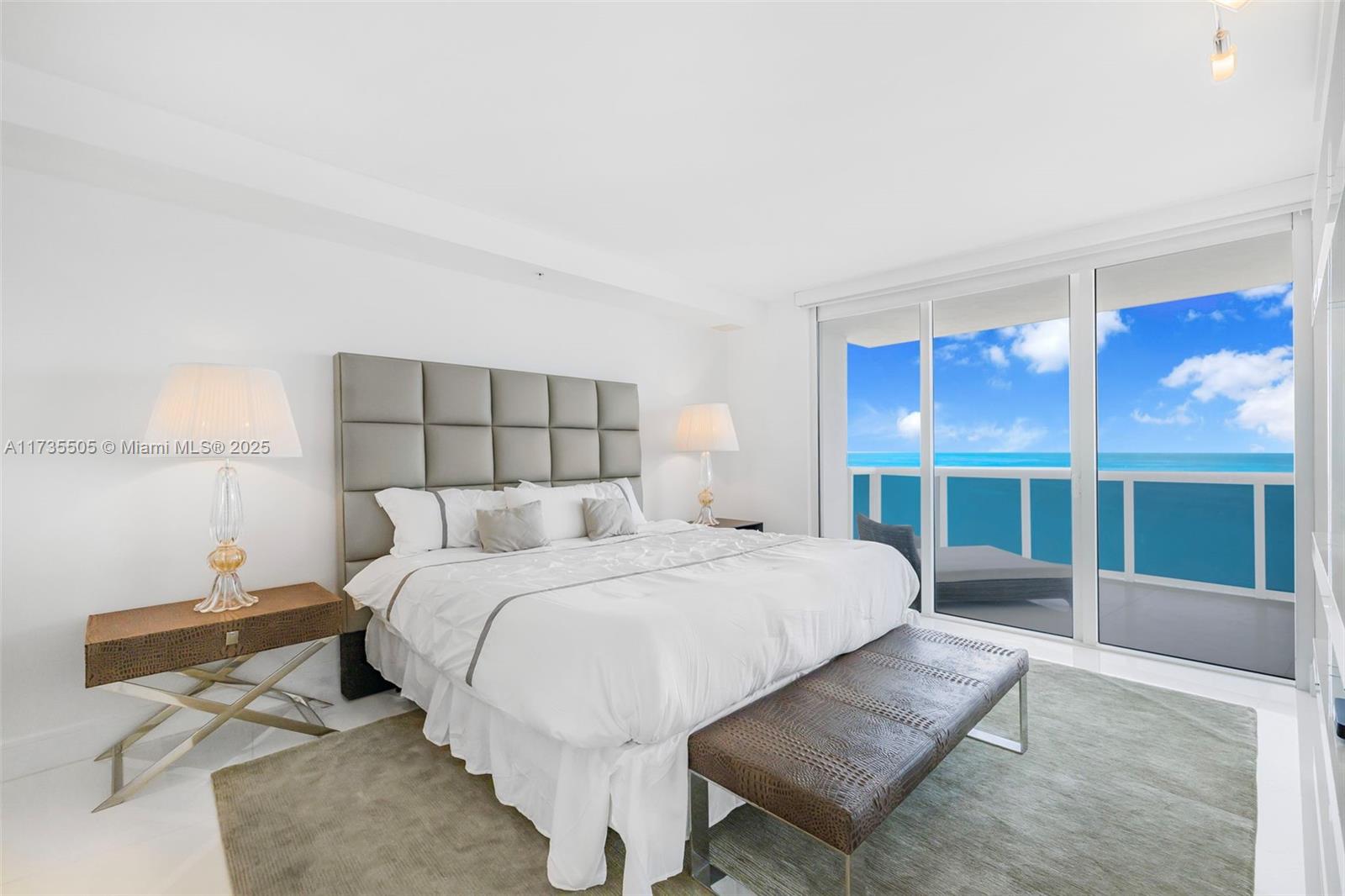 18201 Collins Avenue, Unit PH5109 Sunny Isles Beach, FL 33160 - Photo 35 of 53 a large bedroom with a bed and glass window