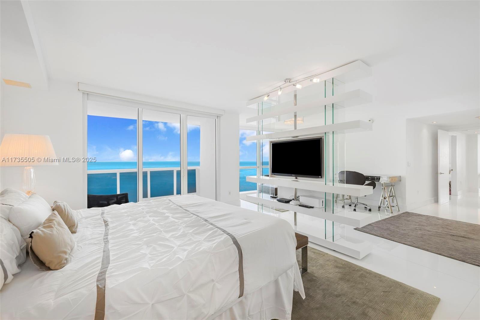 18201 Collins Avenue, Unit PH5109 Sunny Isles Beach, FL 33160 - Photo 36 of 53 a bedroom with a bed window and a flat screen tv