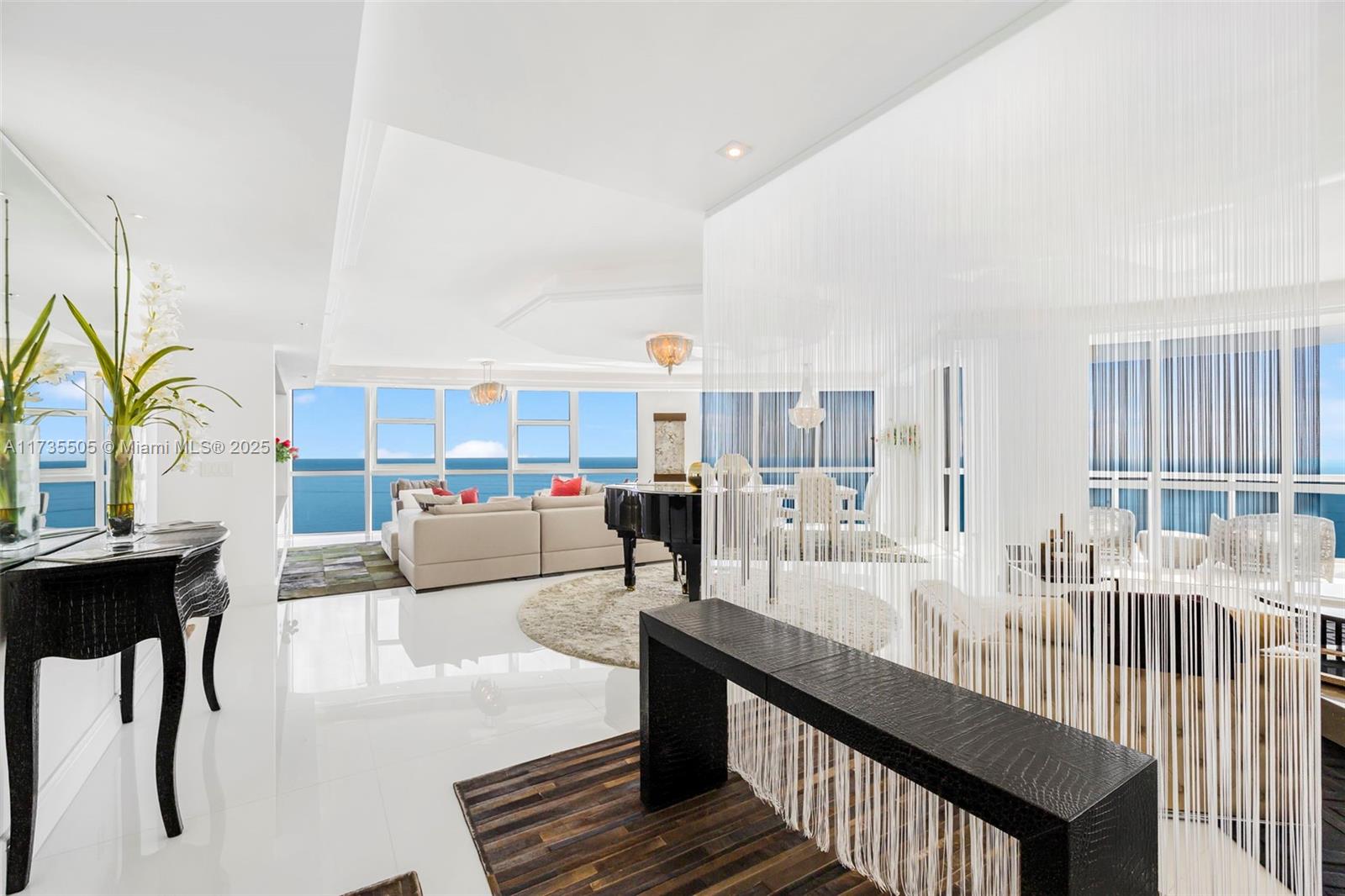 18201 Collins Avenue, Unit PH5109 Sunny Isles Beach, FL 33160 - Photo 4 of 53 a living room with furniture and a table