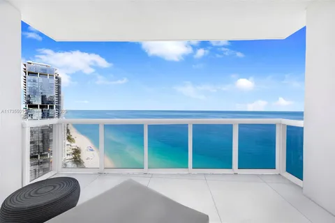 a roof deck with couch and chairs