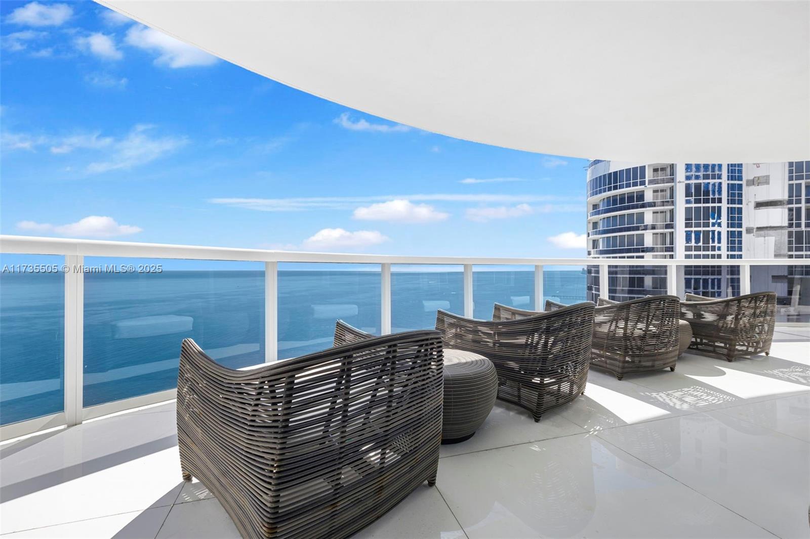 18201 Collins Avenue, Unit PH5109 Sunny Isles Beach, FL 33160 - Photo 44 of 53 a roof deck with couch and chairs