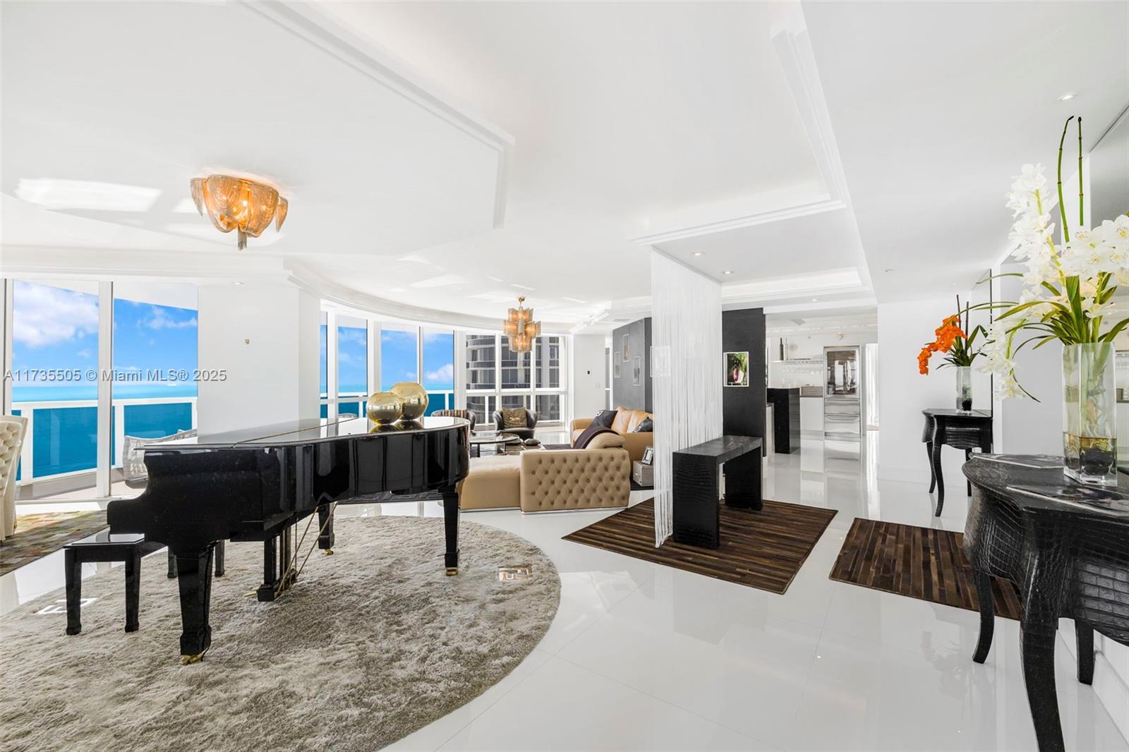 18201 Collins Avenue, Unit PH5109 Sunny Isles Beach, FL 33160 - Photo 5 of 53 a living room with furniture and a table