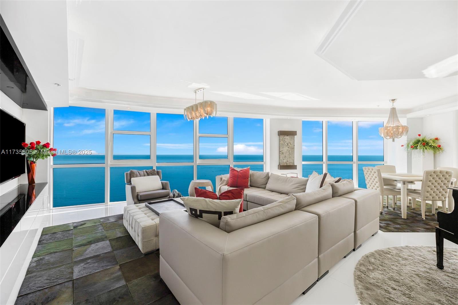 18201 Collins Avenue, Unit PH5109 Sunny Isles Beach, FL 33160 - Photo 6 of 53 a living room with furniture a large window and a flat screen tv