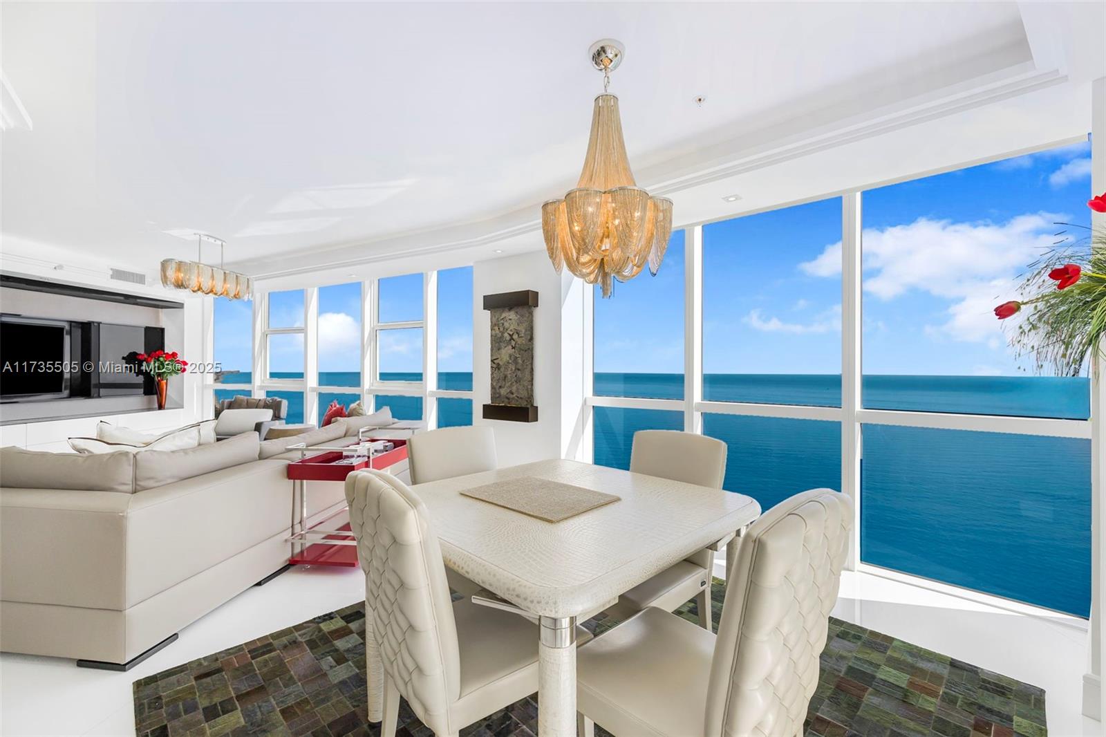 18201 Collins Avenue, Unit PH5109 Sunny Isles Beach, FL 33160 - Photo 10 of 53 a view of a dining room with furniture a chandelier and wooden floor