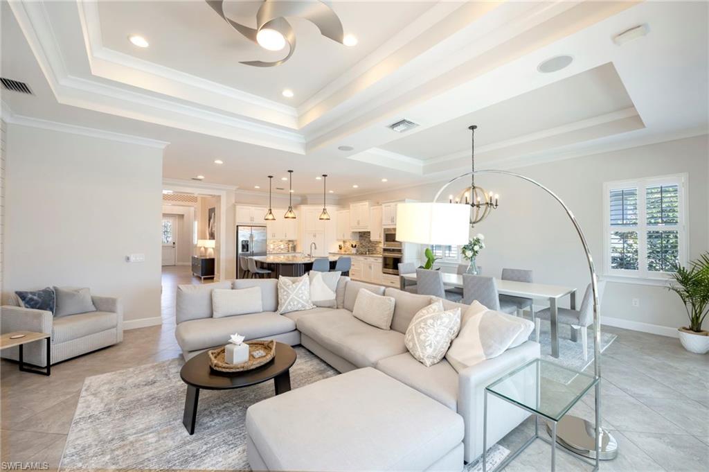 6466 Warwick Avenue Naples, FL 34113 - Photo 2 of 43 a living room with furniture and a chandelier