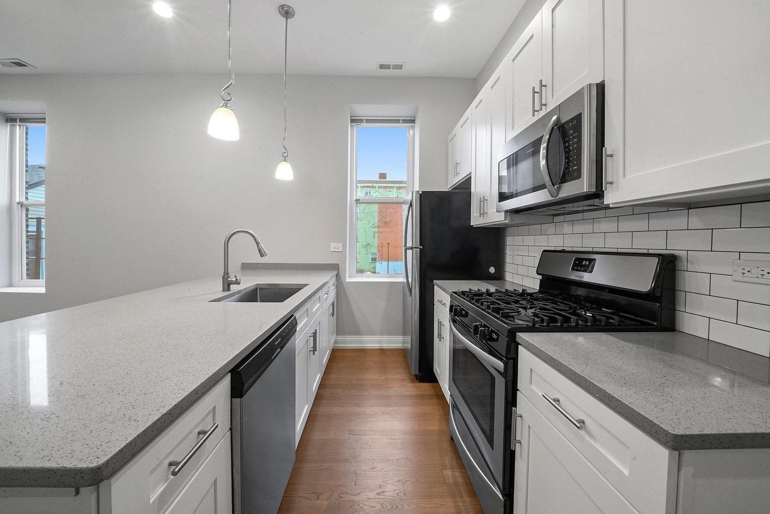 1946 South Racine Avenue, Unit 2R Chicago, IL 60608 - Photo 5 of 12 a kitchen with stainless steel appliances granite countertop a stove a sink and a refrigerator