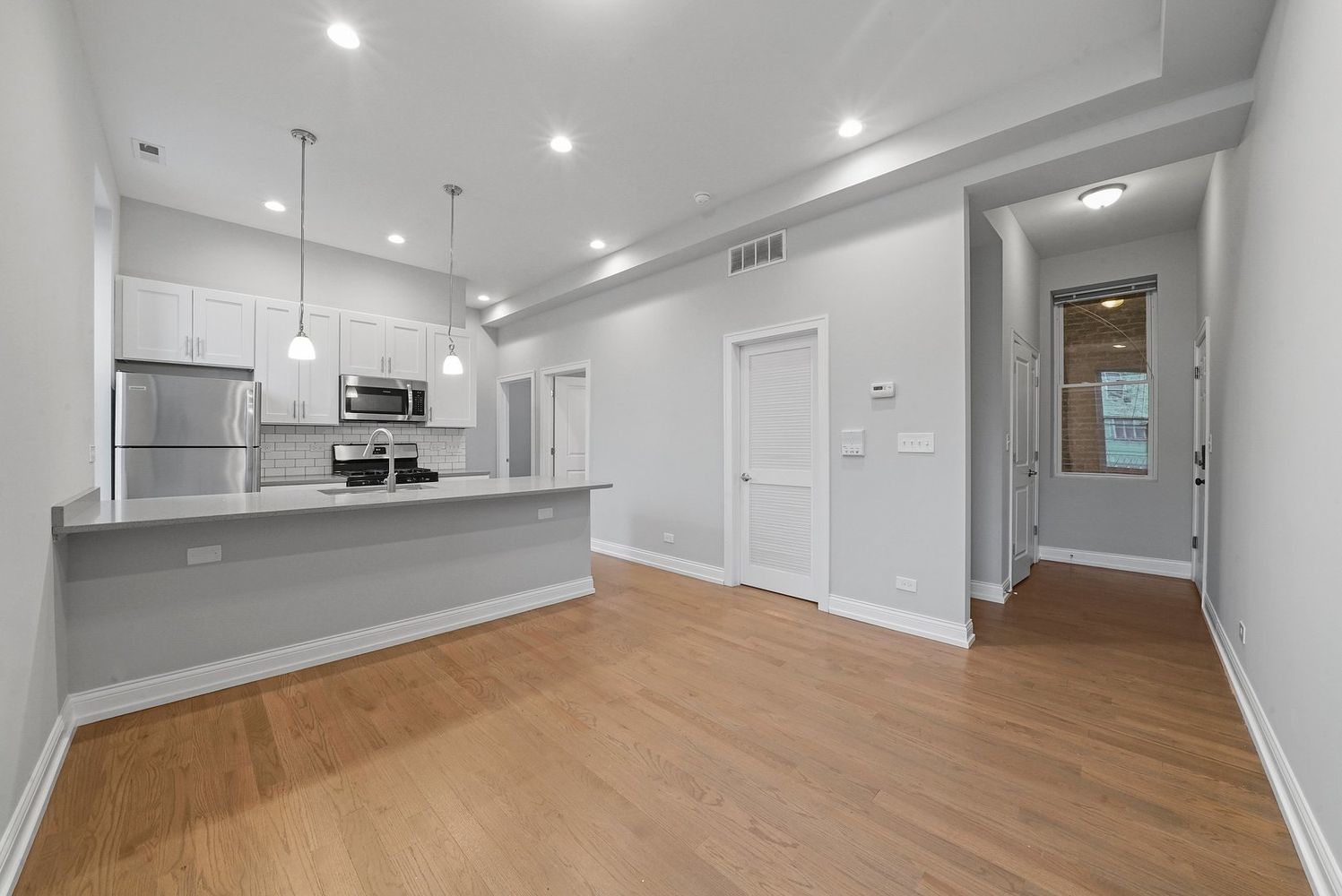 1946 South Racine Avenue, Unit 2R Chicago, IL 60608 - Photo 7 of 12 a large kitchen with stainless steel appliances granite countertop a refrigerator and a sink