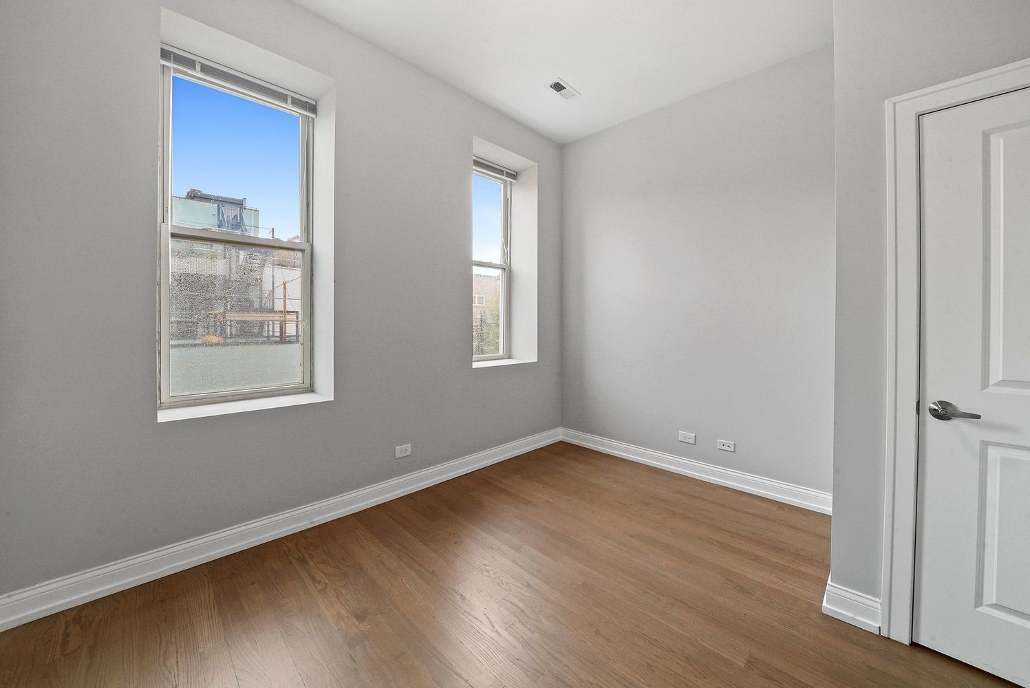 1946 South Racine Avenue, Unit 2R Chicago, IL 60608 - Photo 10 of 12 a view of an empty room with wooden floor and a window