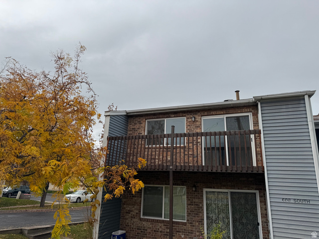 exterior featuring brick siding and light blue horizontal siding