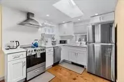 a kitchen with white cabinets and white appliances