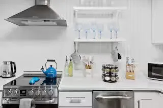 a kitchen with white cabinets and a stove