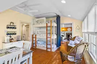 a living room with furniture a flat screen tv and a large window