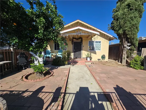 a view of the house with backyard and sitting area