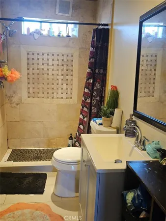 a bathroom with a sink toilet and a mirror