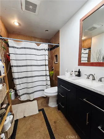 a bathroom with a sink toilet and mirror