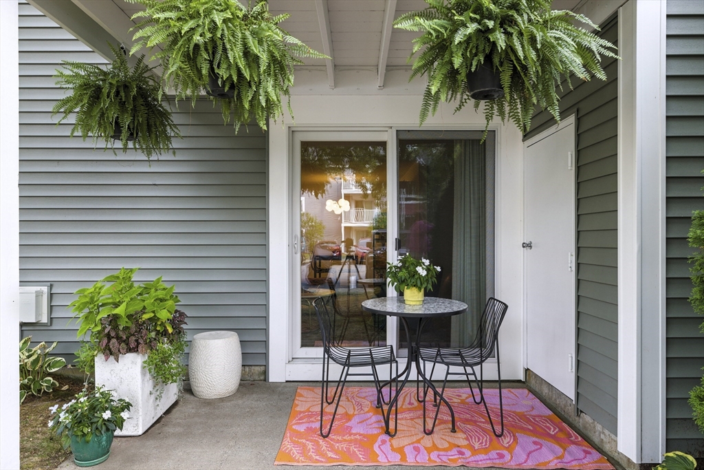 3 Post Oak Lane, Unit 1 Natick, MA 01760 - Photo 12 of 13 a view of a patio with table and chairs and potted plants