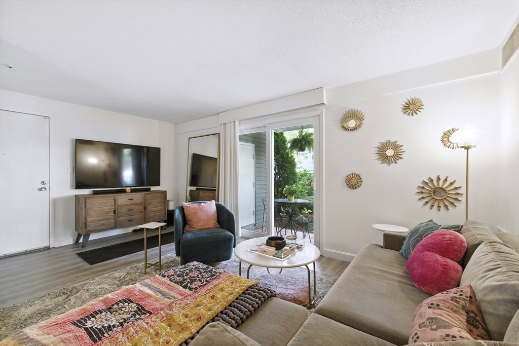 3 Post Oak Lane, Unit 1 Natick, MA 01760 - Photo 2 of 13 a living room with furniture and a flat screen tv