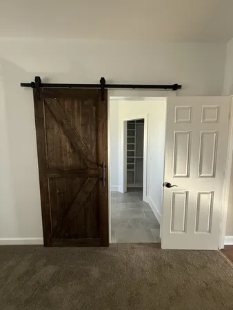 a spacious bathroom with a bathtub double sink and mirror