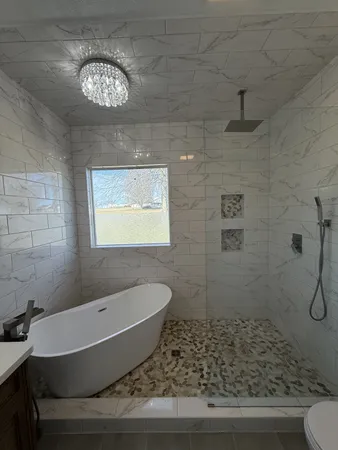 a view of a bedroom with a bed and window