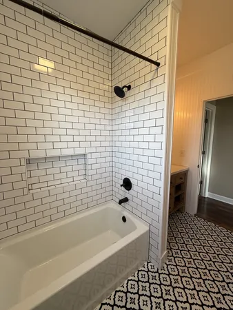 a view of a room with white walls washer and a window