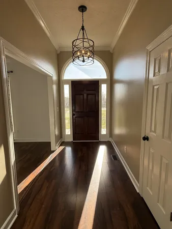 a room with wooden floor and window