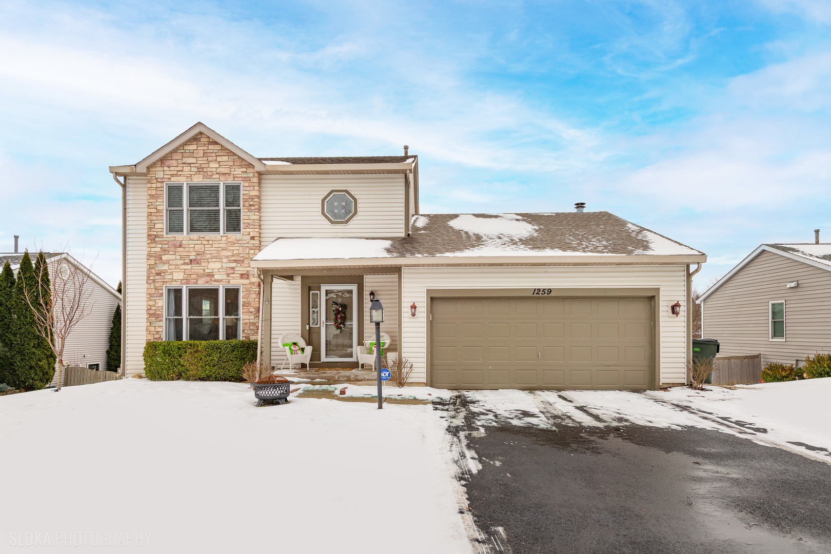 a front view of a house with a yard and garage
