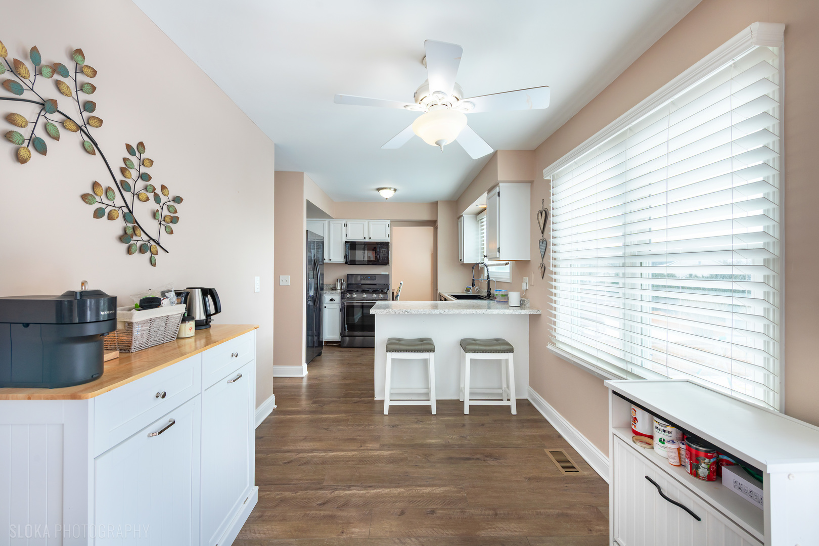 1259 Chickory Ridge Trail Cary, IL 60013 - Photo 8 of 31 a large white kitchen with stainless steel appliances kitchen island a large counter space and a window