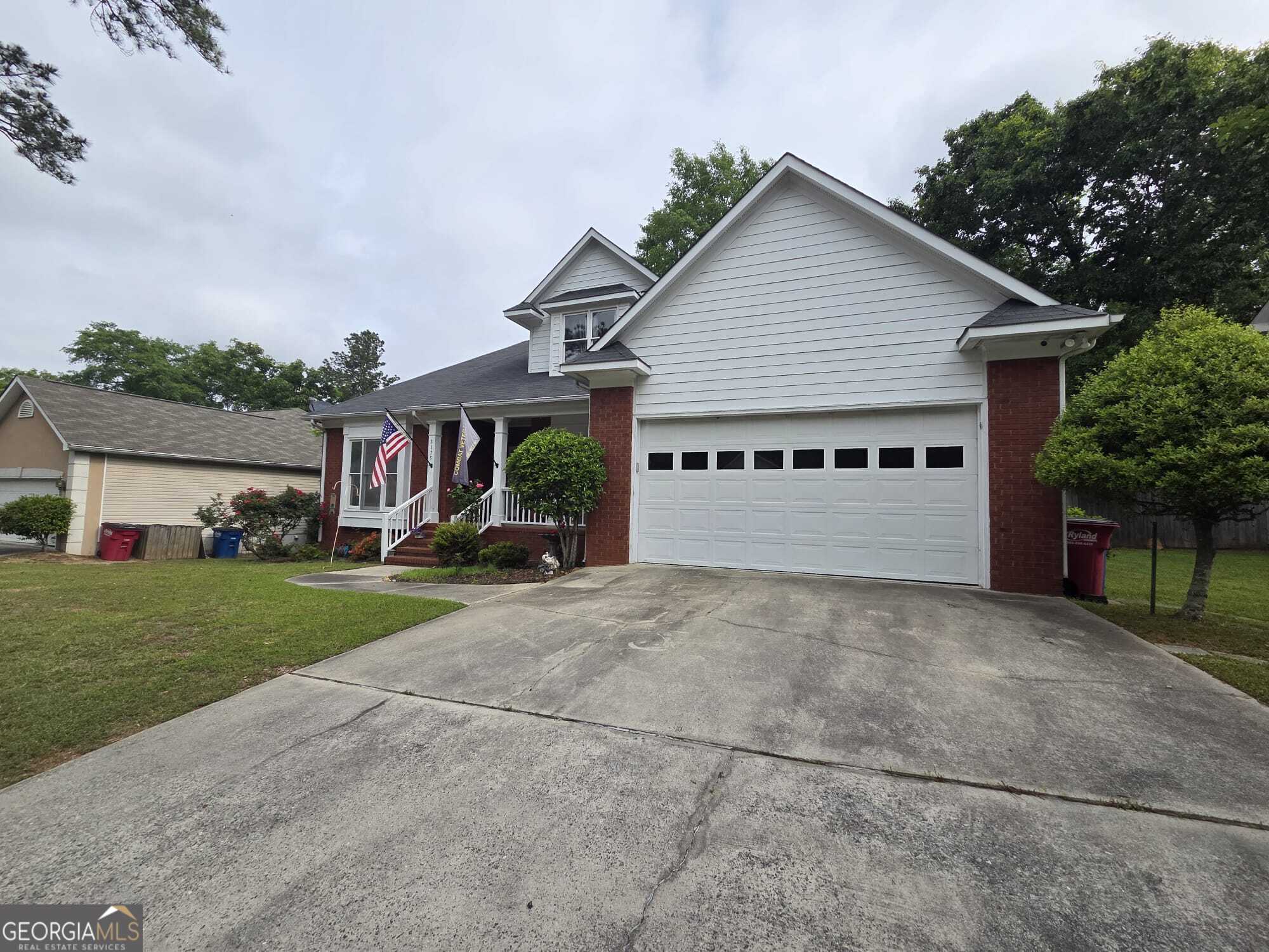 a view of a house with a yard and garage