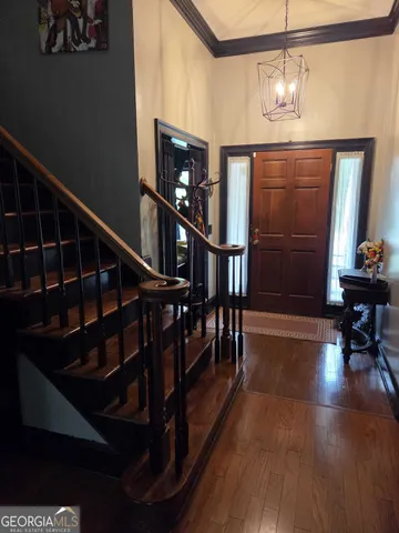 a view of entryway and hall with wooden floor