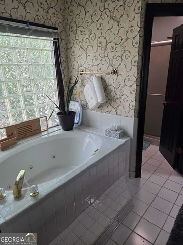 a bathroom with a bathtub and a sink