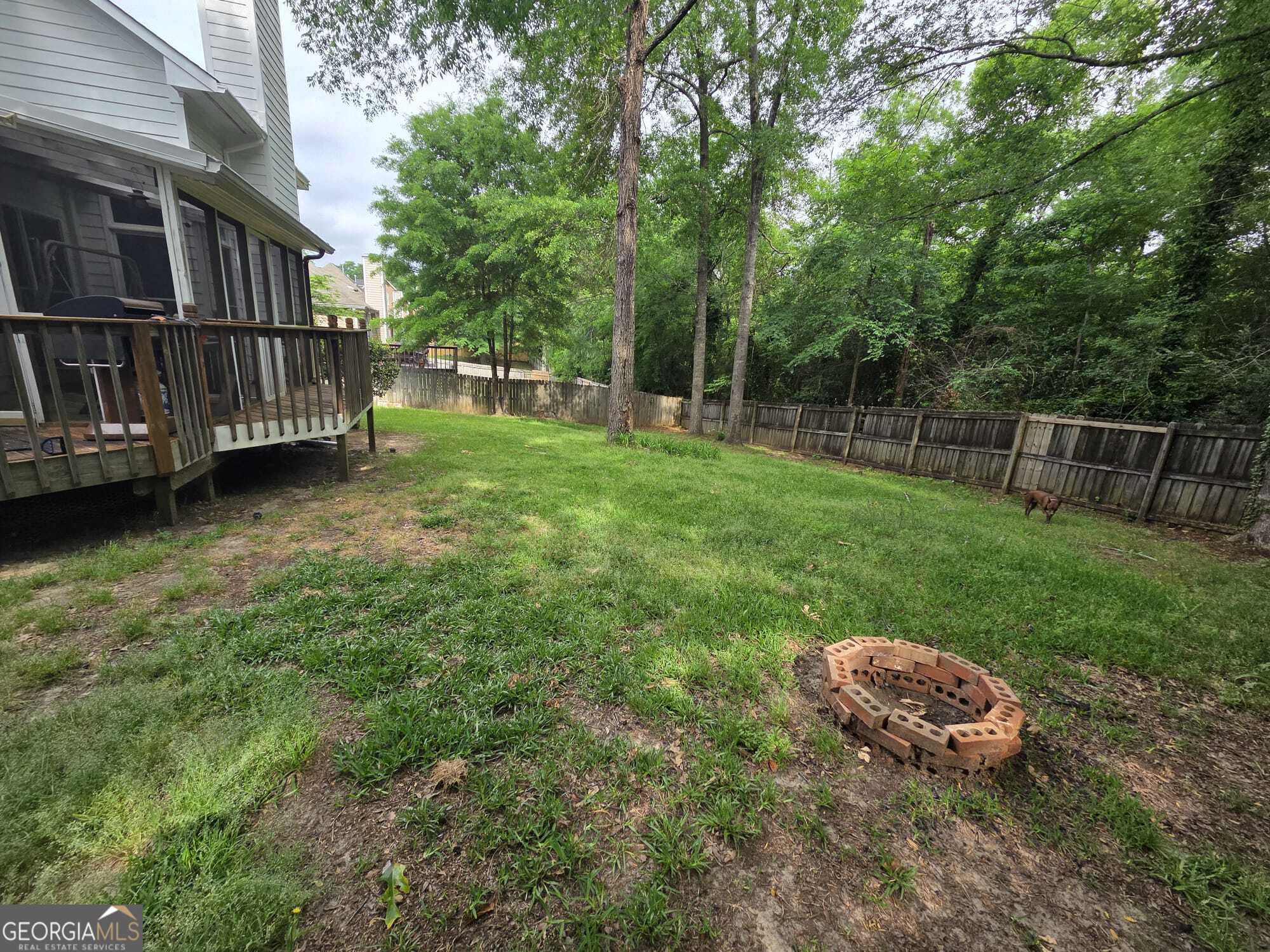 3175 Stinsonville Road Macon, GA 31204 - Photo 3 of 13 a view of a backyard with a small deck and a garden