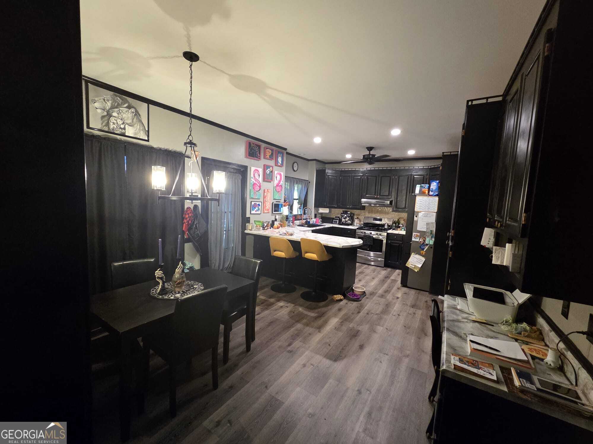 3175 Stinsonville Road Macon, GA 31204 - Photo 5 of 13 a kitchen with stainless steel appliances kitchen island granite countertop a refrigerator a stove and a sink with wooden floor