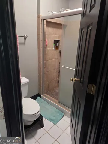 a bathroom with a toilet and a shower