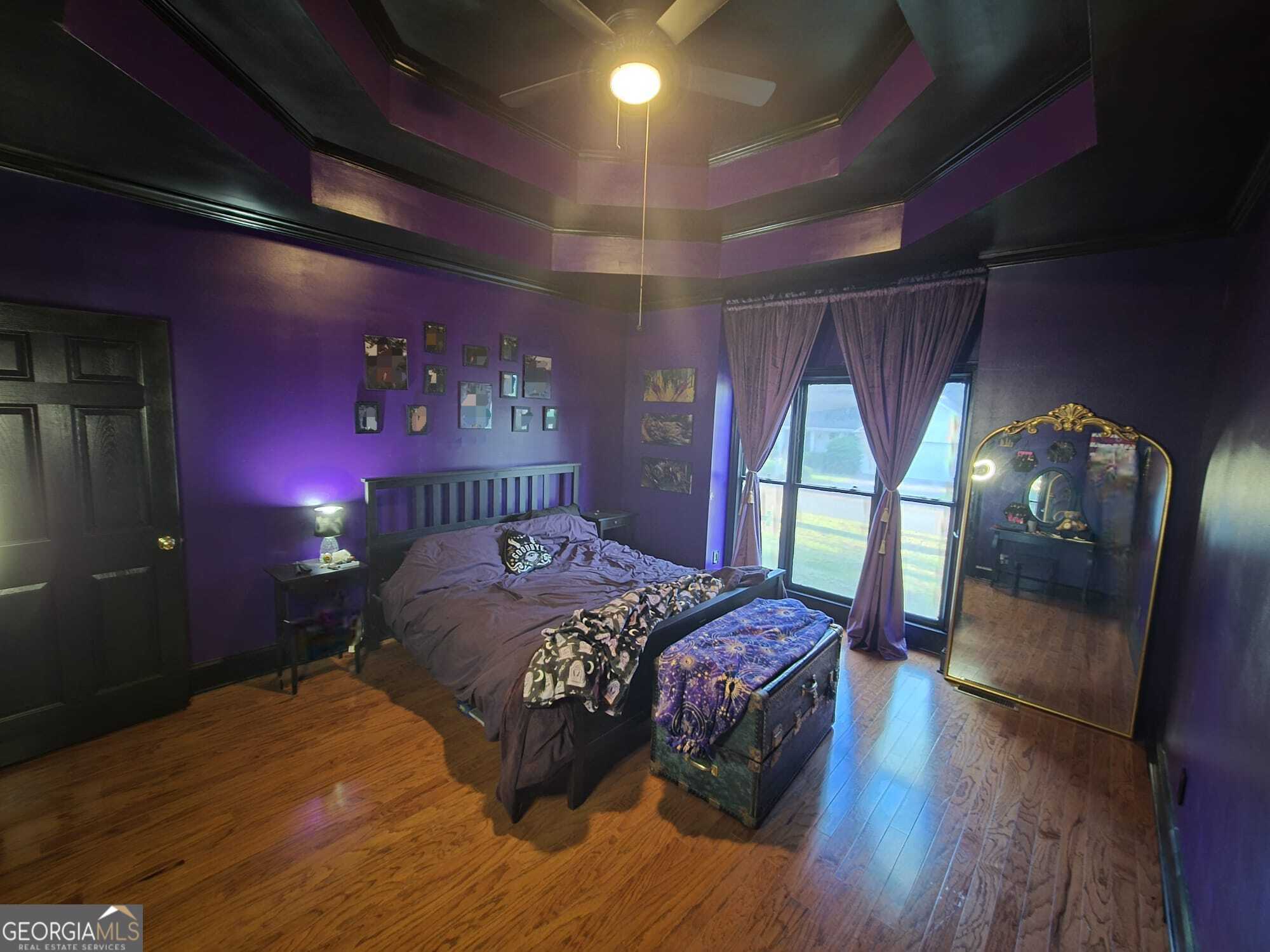 3175 Stinsonville Road Macon, GA 31204 - Photo 8 of 13 a bedroom with a bed mirror and a large window